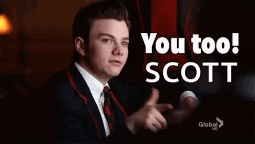 a man in a suit and tie is giving a thumbs up and says `` you too scott '' .