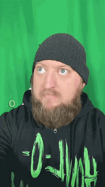 a man with a beard is wearing a black hoodie that says o-lvah