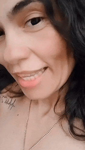 a close up of a woman 's face with a tattoo on her shoulder that says ' i love you ' on it