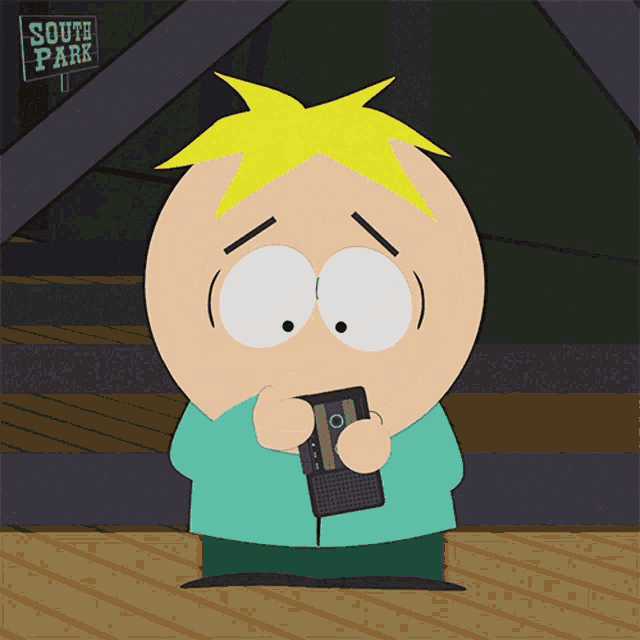 a cartoon character holding a cell phone in front of a south park sign