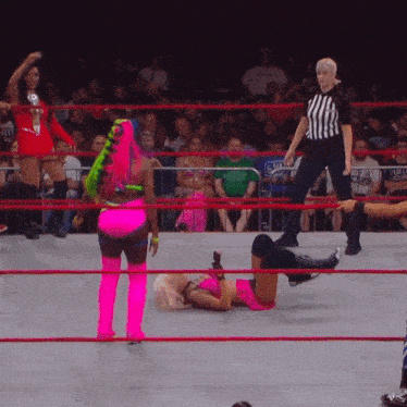 a woman in a pink outfit is laying on the ground