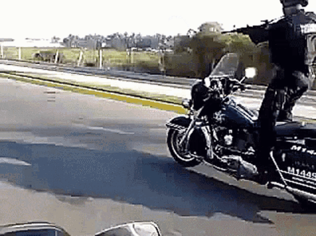 a police officer is riding a motorcycle with a license plate that says m14415