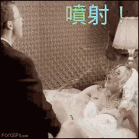 a man in a suit is standing next to a woman laying in bed