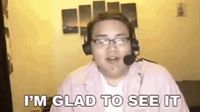 a man wearing headphones and glasses is saying `` i 'm glad to see it ''