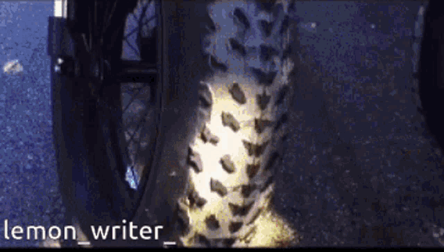 a close up of a bicycle tire with the words lemon writer written below it