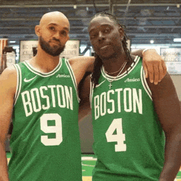 two boston celtics players pose for a photo