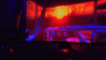 a computer monitor is displaying a video game with a sunset in the background