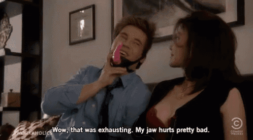 a man is holding a pink toy while a woman says wow that was exhausting my jaw hurts pretty bad ..