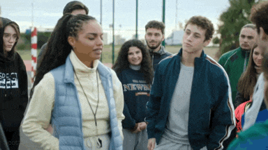 a group of people including a girl wearing a sweatshirt that says ' new ' on it