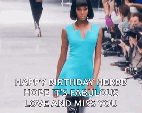 a woman in a blue dress is walking down a runway and says happy birthday herbb hope it 's fabulous love and miss you