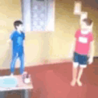 a blurry picture of two children standing next to each other on a table .