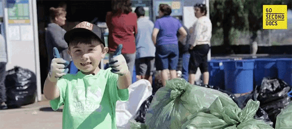 a young boy giving a thumbs up in front of a sign that says 60 seconds docs