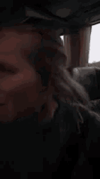a woman is making a funny face while sitting in a car .