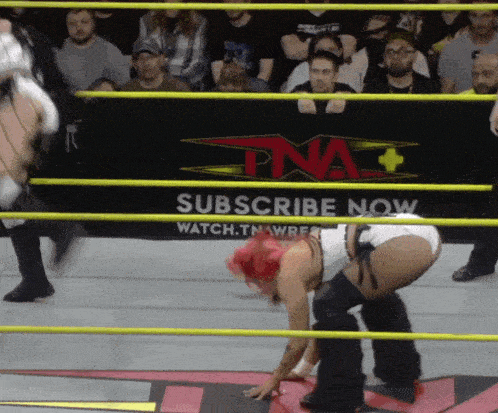 a wrestling ring with a sign that says subscribe now on it