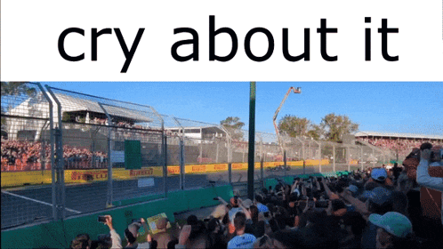 a crowd at a race track with the words cry about it