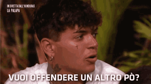 a man with a tattoo on his face says vuoi offendere un altro po