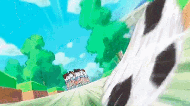 a group of people are riding a roller coaster in a park with trees in the background .