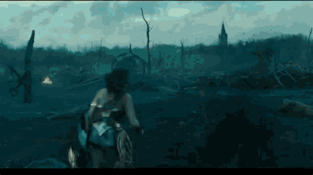 wonder woman is running through a field in a movie scene .