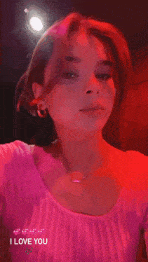 a girl with a butterfly on her nose is wearing a pink top