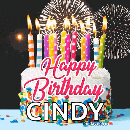a birthday cake with candles and fireworks in the background .