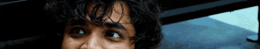 a close up of a person 's face with a tear running down his cheek