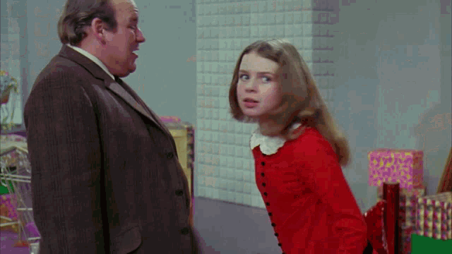 a man and a girl are standing next to each other