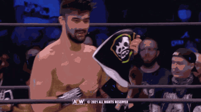 a man in a boxing ring holding a sign that says a w