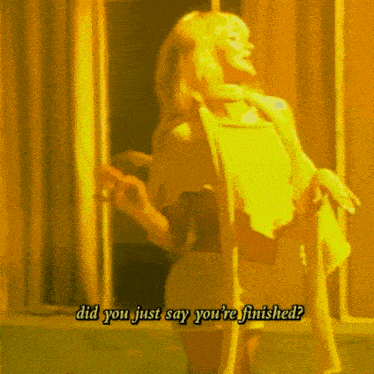 a woman in a yellow dress is standing in front of a door with the words did you just say you 're finished