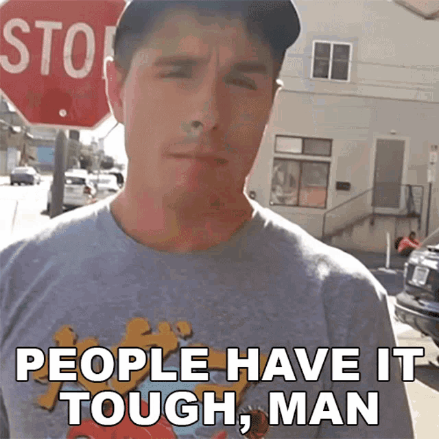 a man wearing a t-shirt that says " people have it tough man "