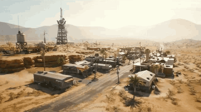 an aerial view of a desert landscape with a few buildings and a water tower with the word phoenix on it