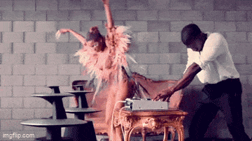 a man and a woman are dancing in front of a brick wall with imgflip.com at the bottom of the screen