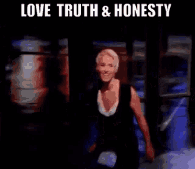 a group of women are dancing on a stage with the words love truth and honesty .
