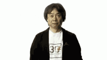 a man standing in front of a zelda breath of the wild logo