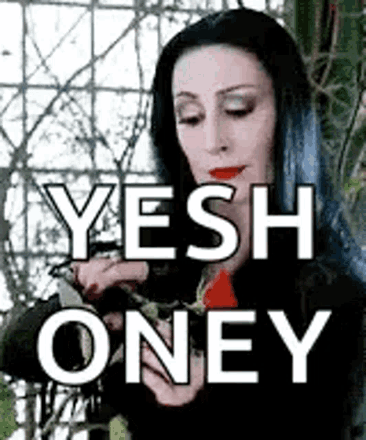 a woman with long black hair is holding a plant in her hand and says yesh oney .