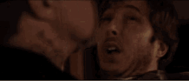 a close up of a man 's face with the words drink written above him