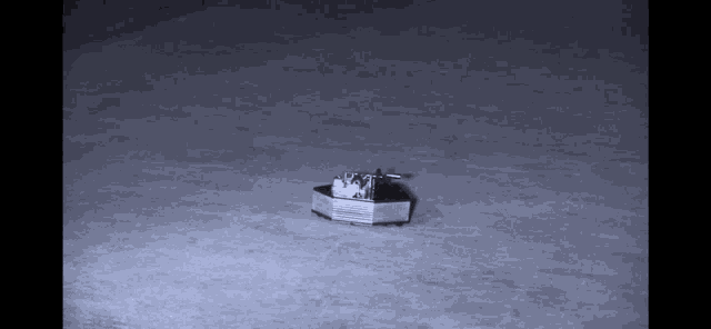 a black and white photo of a small boat with the letters v and a on it