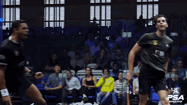 a man in a black shirt with psa world tour written on the front