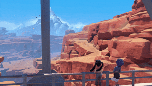 a couple of people standing on a railing overlooking a canyon
