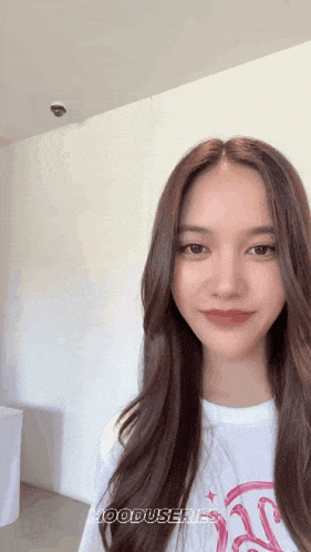 a woman with long brown hair is wearing a white shirt that says mooduseries