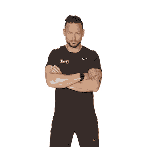 a man with his arms crossed wears a shirt that says nike on it