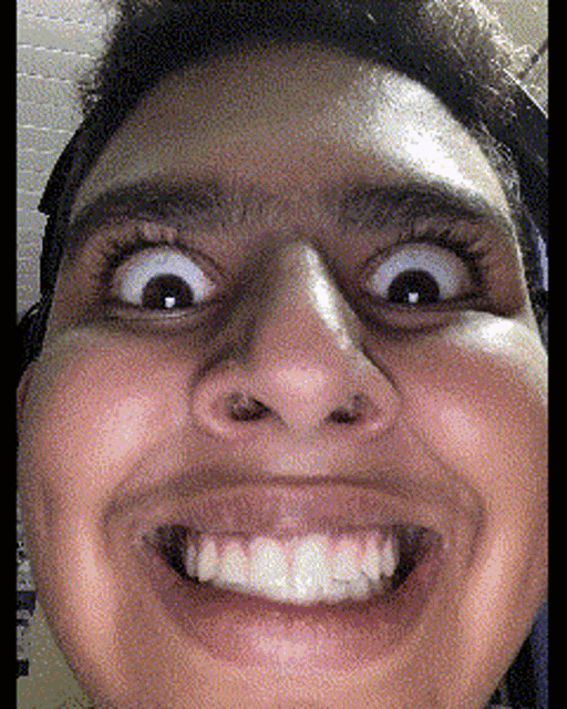 a close up of a person 's face with their mouth open