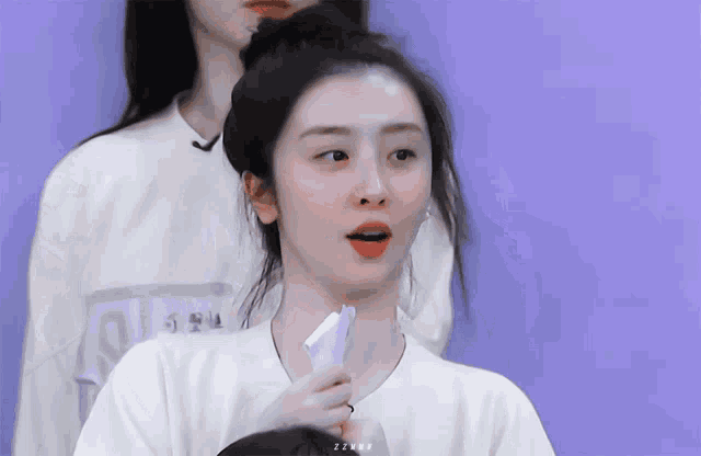 a woman wearing a white shirt with a name tag that says ' i'm a ' on it