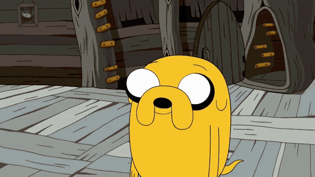 a cartoon character named jake from adventure time stands in front of a wooden house