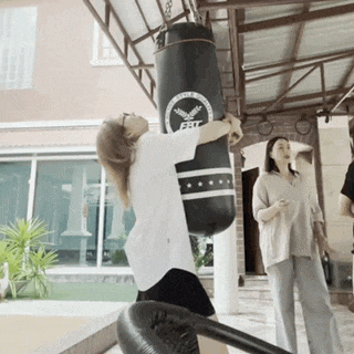 a woman is hitting a punching bag that says bbc