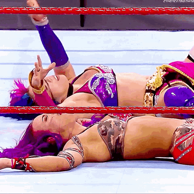 two women are laying on the floor in a wrestling ring with the hashtag #thenextbig thing
