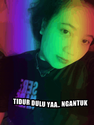 a woman taking a selfie with the words tidur dulu yaa ngantuk