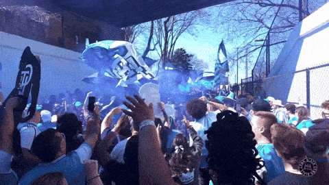 a crowd of people holding up signs that say tp