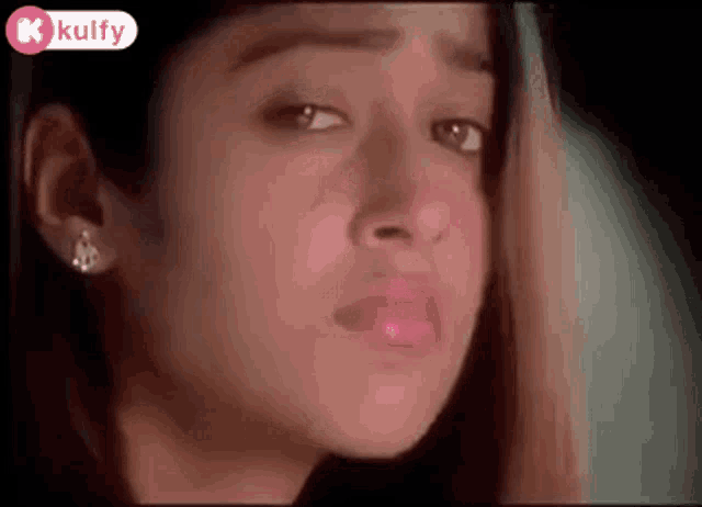a close up of a woman 's face with the words kulfy on the bottom right
