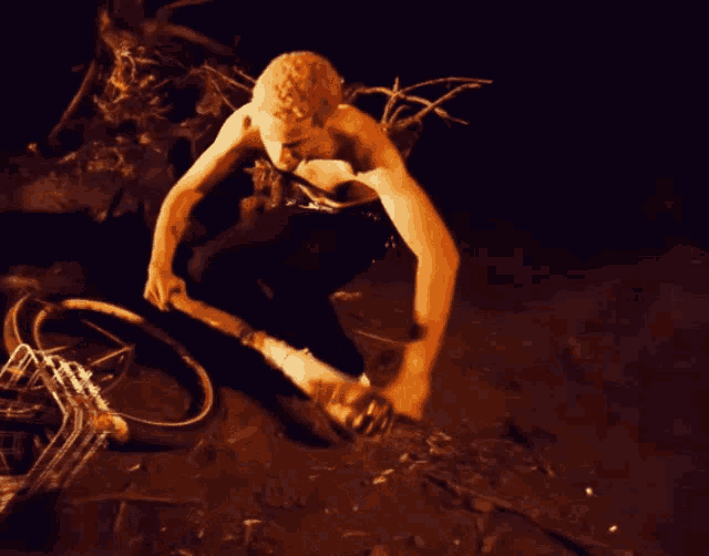 a man without a shirt is holding a hammer