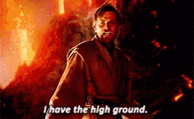 a man standing in front of a fire says i have the high ground